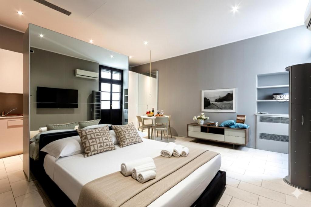 a bedroom with a large bed and a dining room at Casa Leon in Mantova