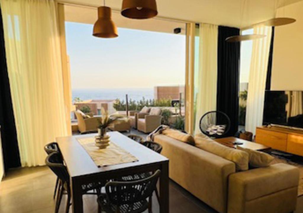 a living room with a couch and a table at Vila Mara in Dhërmi