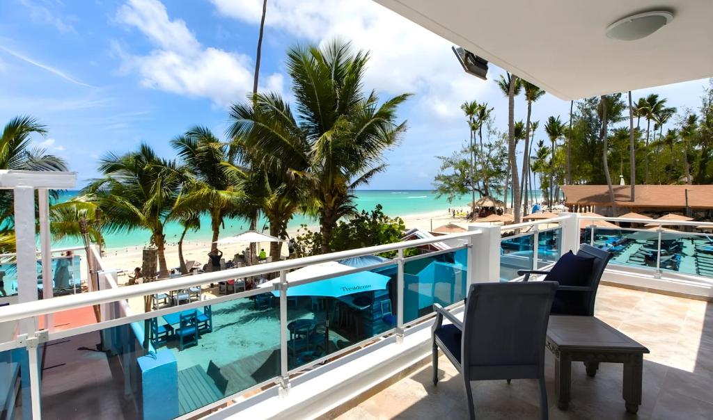 a balcony with a view of the beach and ocean at Hotel Checkin El Cortecito Beach in Punta Cana