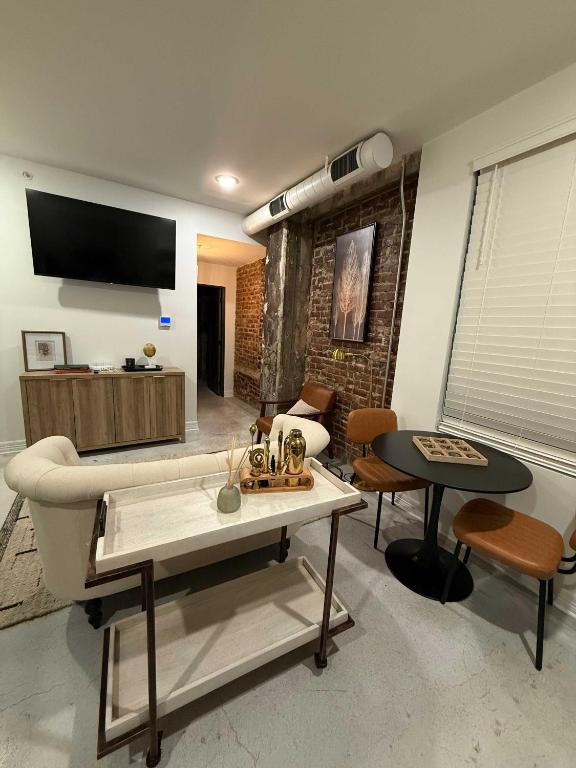 a living room with a couch and a table at Park Hotel 1BR Suite 210 in Chattanooga