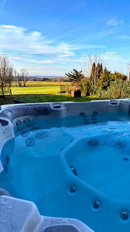 a hot tub with a view of a field at Mossefat in Sprimont