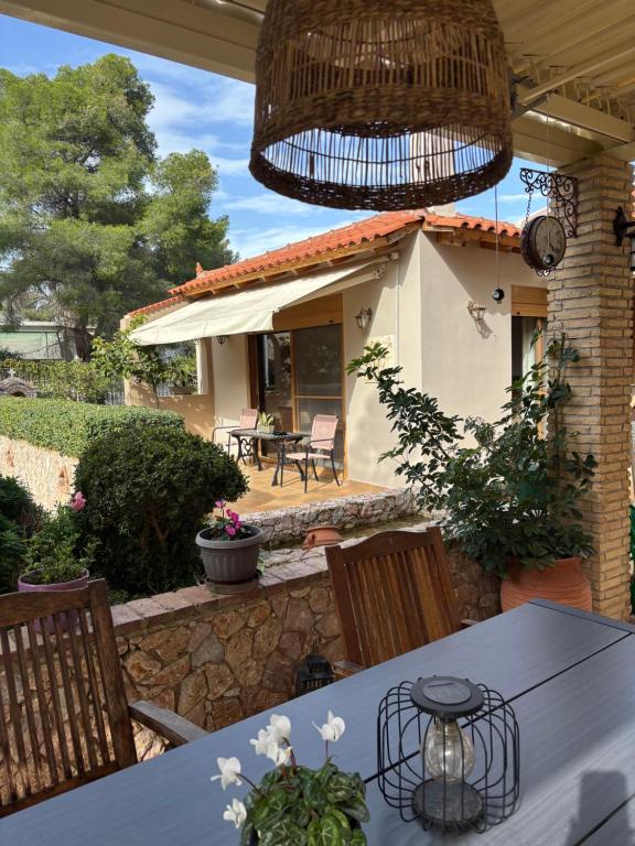 a patio with a table and chairs and a house at Studio with garden in Selínia
