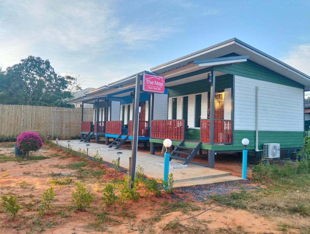 a small house with a for sale sign in front of it at The Nap Koh Yao Yai in Ban Nai Wat