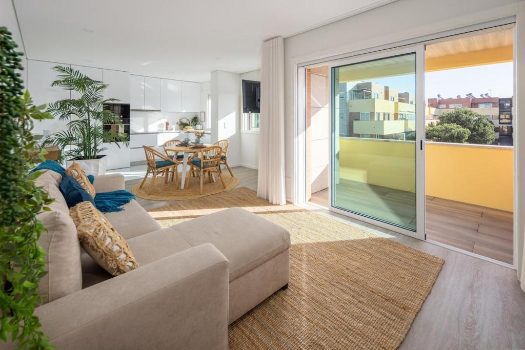 a living room with a couch and a table at Aurora do Furadouro II in Ovar