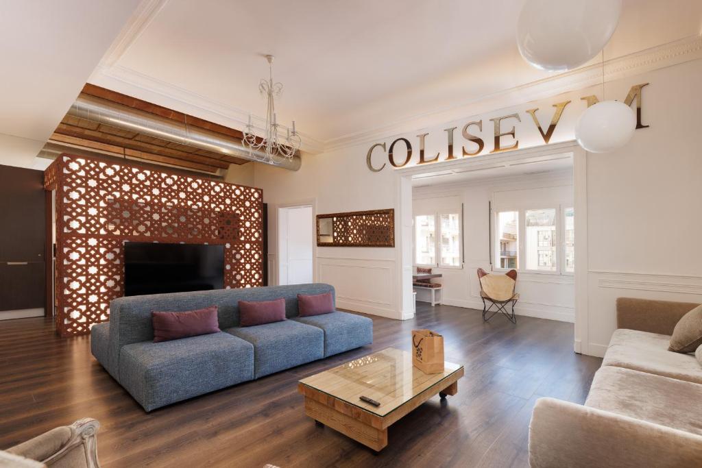a living room with a couch and a fireplace at Enjoybcn Coliseum Apartments in Barcelona