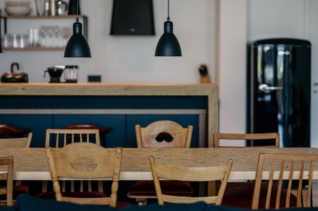 a dining room with a wooden table and chairs at Walser ART in Mittelberg