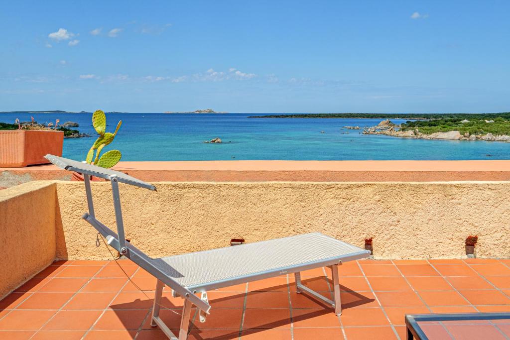 a chair sitting on a terrace with a view of the ocean at Marineledda la terrazza sul golfo in Santa Marinella
