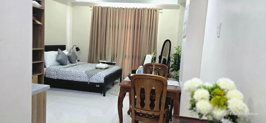 a living room with a bed and a table and chairs at JZA Staycation 1 in Mactan