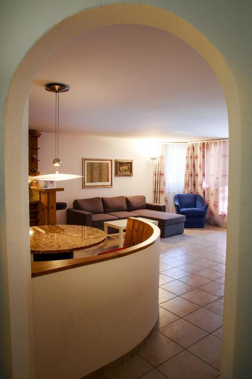 a living room with a couch and a table at Chesa Foulla Rosa - Celerina in Celerina