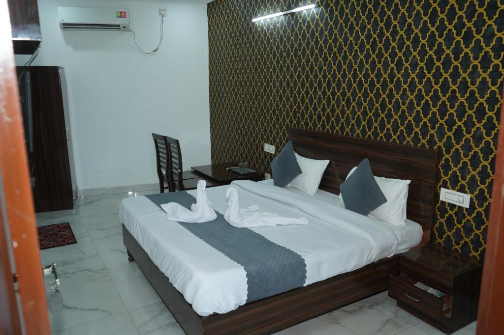 a bedroom with a bed with white shoes on it at Hotel the Chandigarh in Chandīgarh