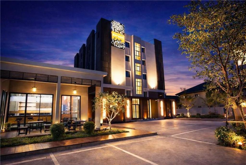 a building with a parking lot in front of it at Collection O The Bangkok Cha Cha Suite in Bangkok
