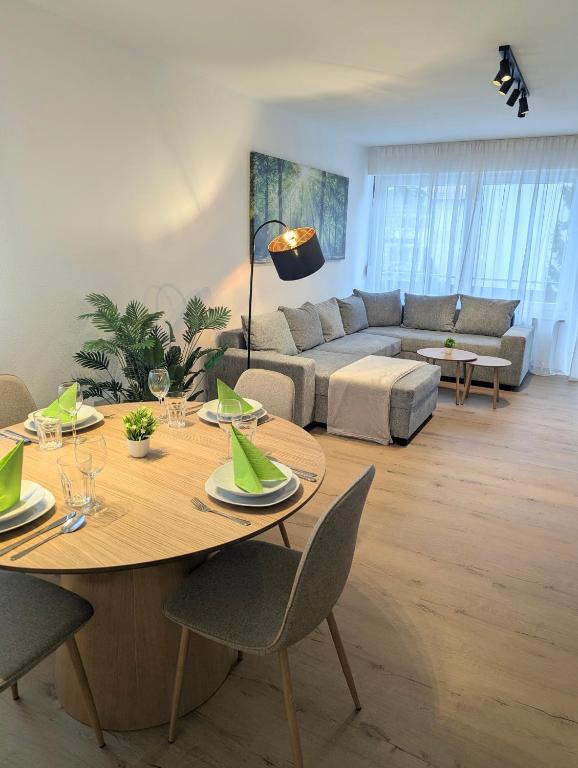 a living room with a table and a couch at Sauna Apartment Adelina Bad Wörishofen in Bad Wörishofen