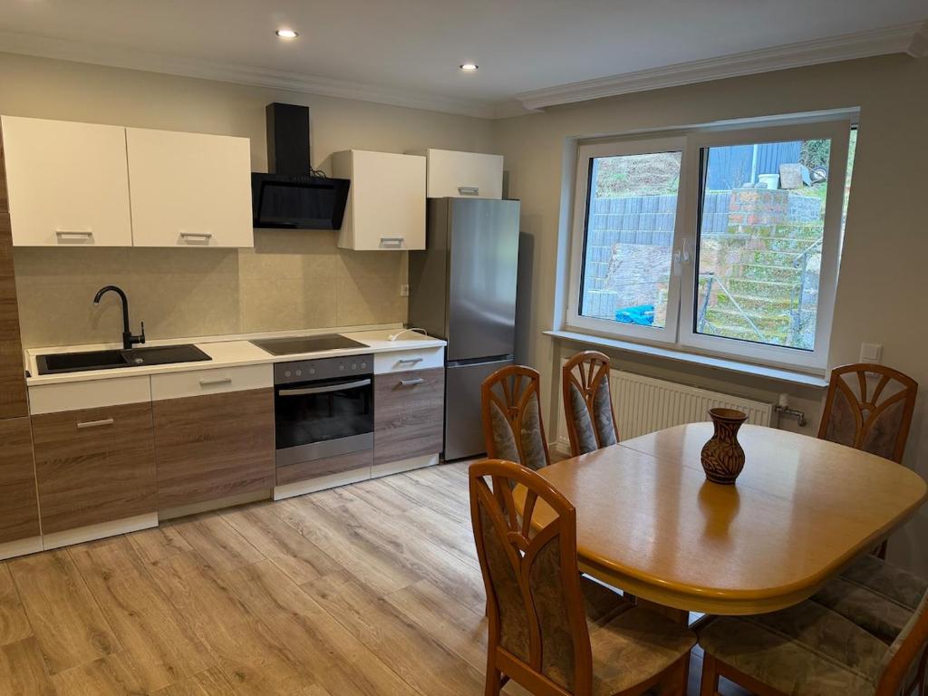 a kitchen with a wooden table and a dining room at Apartment in Otterberg in Otterberg