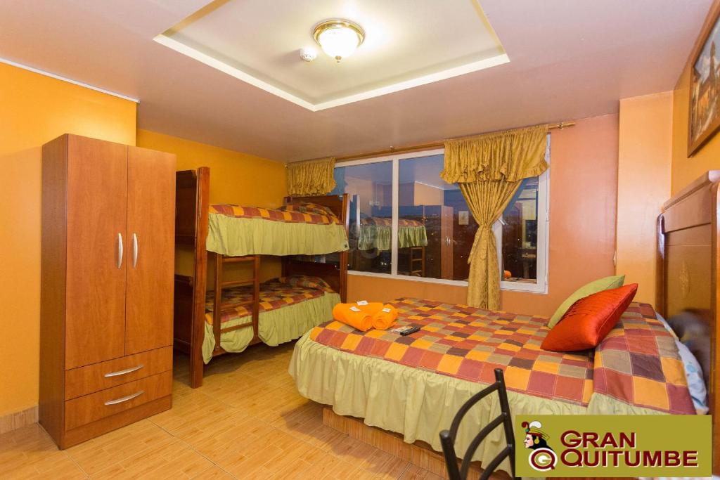 Postel nebo postele na pokoji v ubytování Hotel Gran Quitumbe