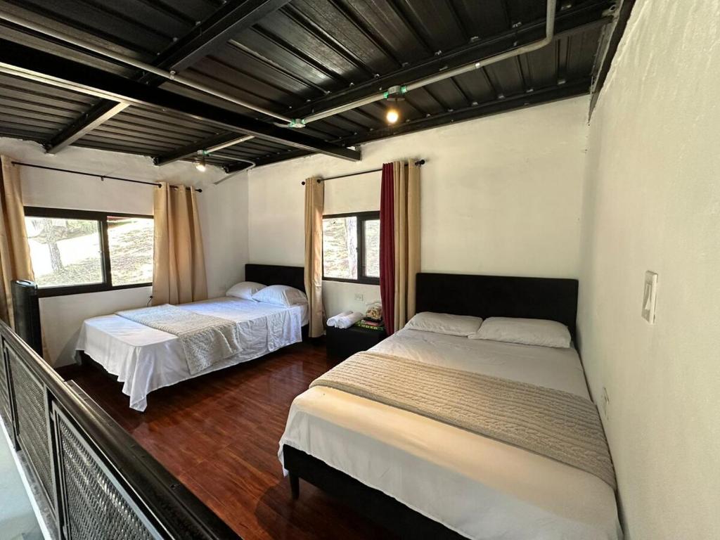 a bedroom with two beds in a room at Blue Dream in Los Altos de Cerro Azul