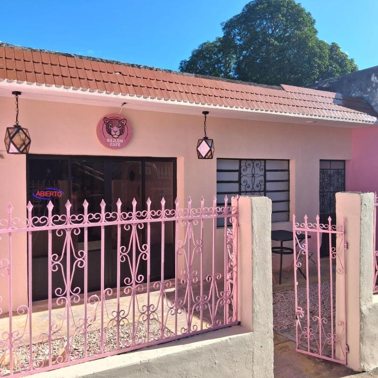 a pink house with a gate in front of it at casa bajlum in Valladolid