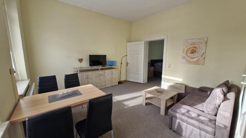a living room with a couch and a table at Inselglück in Malchow