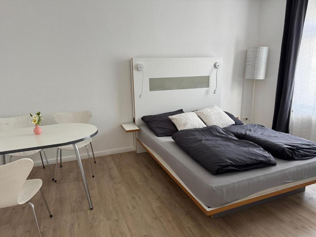 a bed in a room with a table and a bedskirtspectspectspectspects at Dream Holiday Haus in Uetersen