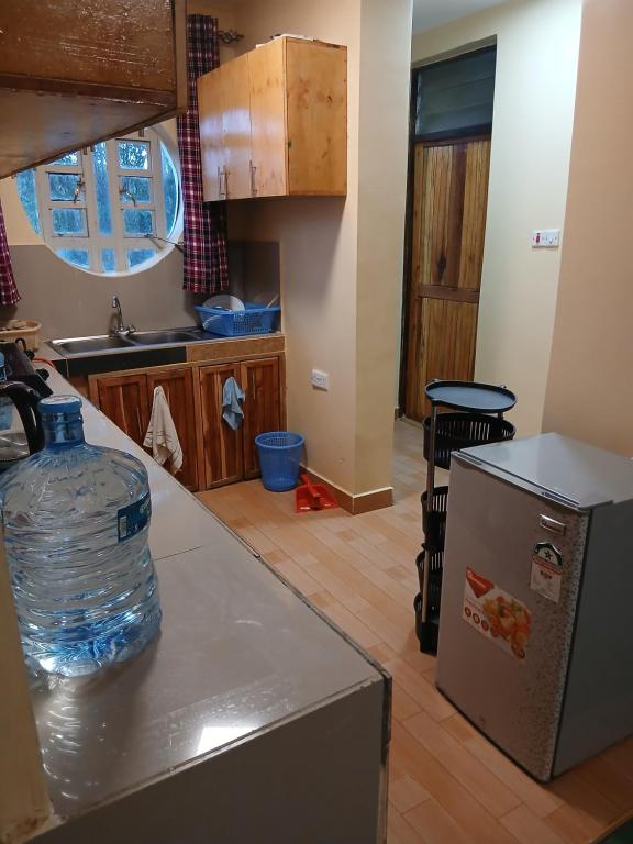 a kitchen with a large bottle of water on a counter at Marima Safari in Sekenani