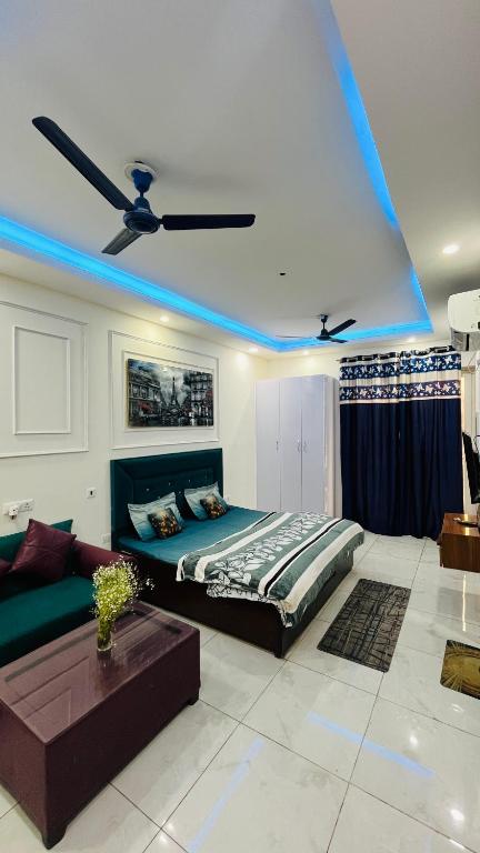 a bedroom with a bed and a blue light at The Blue Heaven in Noida