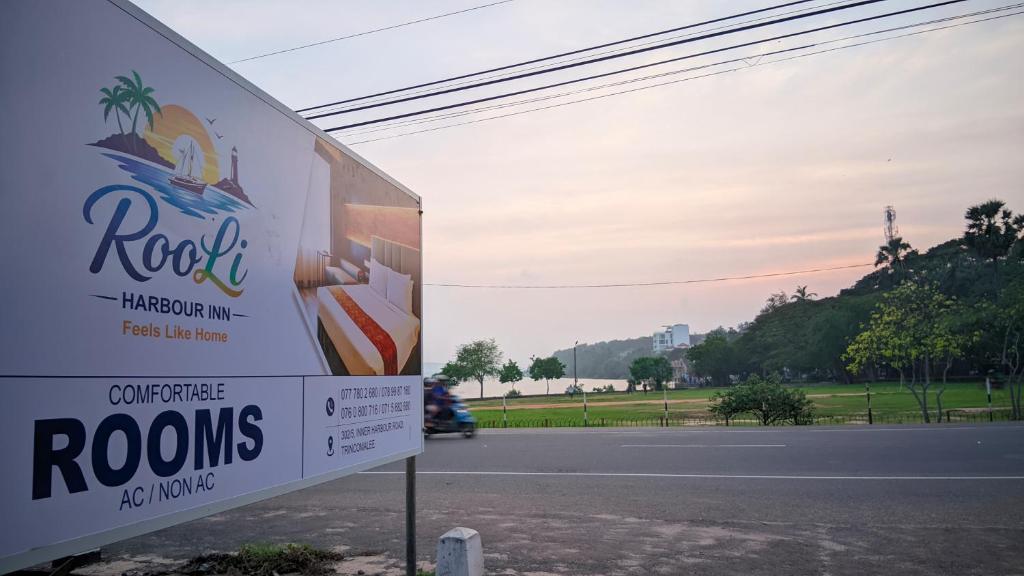 a sign on the side of a road at RooLi Harbour Inn-Trincomalee in Trincomalee