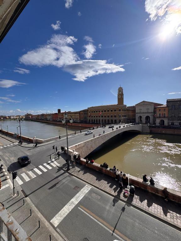 a bridge over a river in a city at Lungarno Suite in Pisa