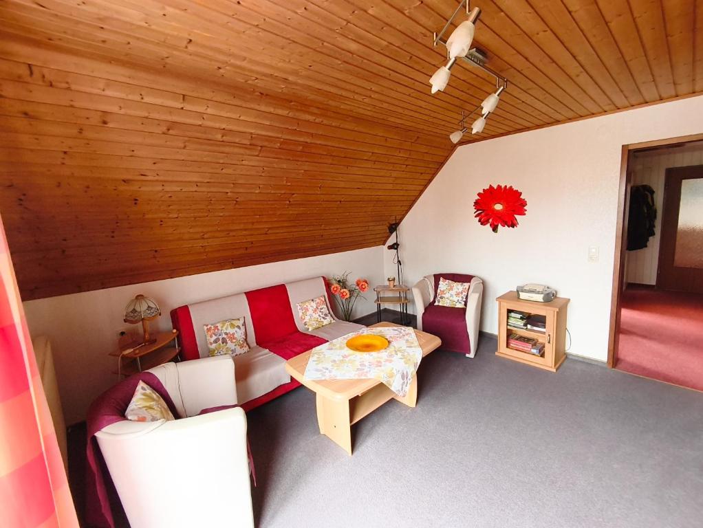a living room with a couch and a table at Gästehaus Heuchert in Meersburg