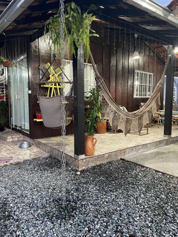 a water feature in a building with a tree at Pousada 03 do vô Bi in São Francisco do Sul