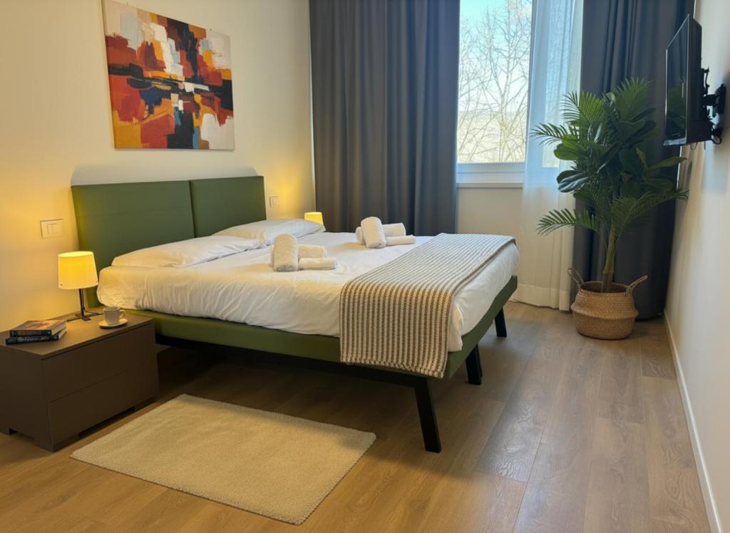 a bedroom with a bed with two towels on it at SPACE101 City Apartment & Studio in Limito di Pioltello