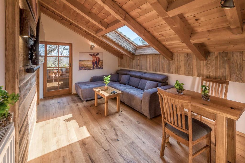 a living room with a couch and a table at Bergliebe in Schleching