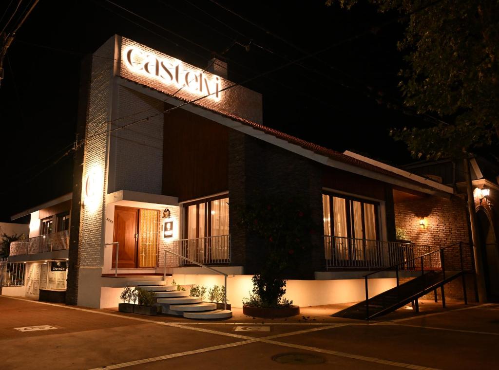 a building with a sign on the side of it at night at Castelvi casa boutique in Saladillo