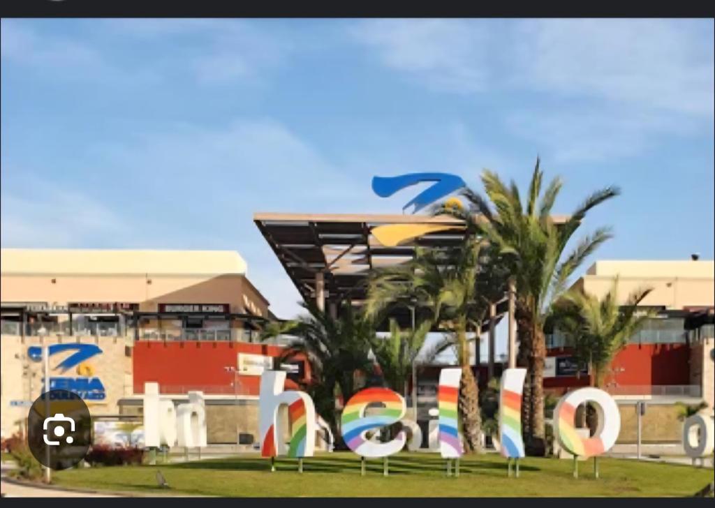 a park with a sign in front of a building at résidence 2 chambres avec piscine proche mer in Orihuela Costa