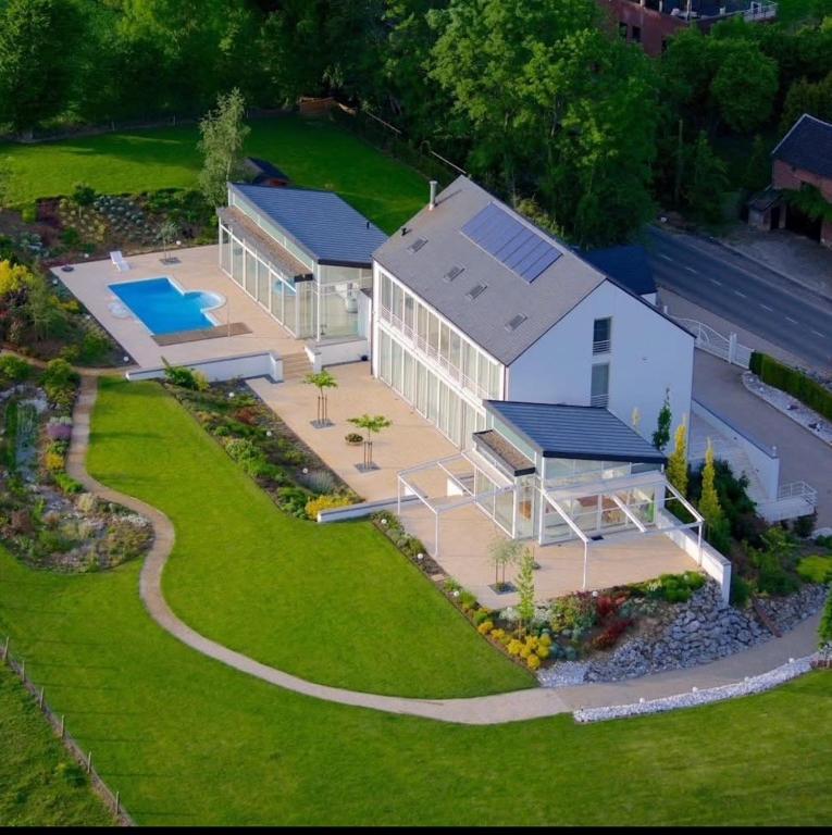 an aerial view of a house with a swimming pool at Villa Bianca in Dalhem
