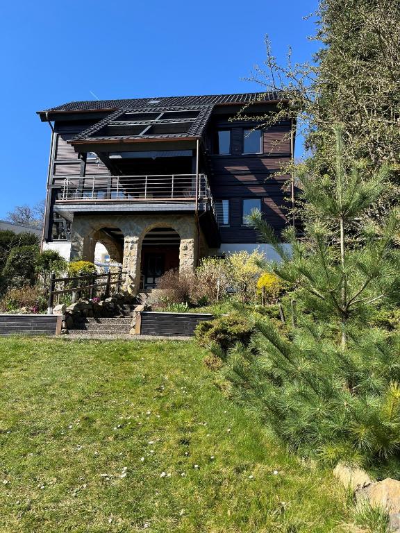 a house with solar panels on the roof at Ferienwohnungen Am Elfenstein in Bad Harzburg
