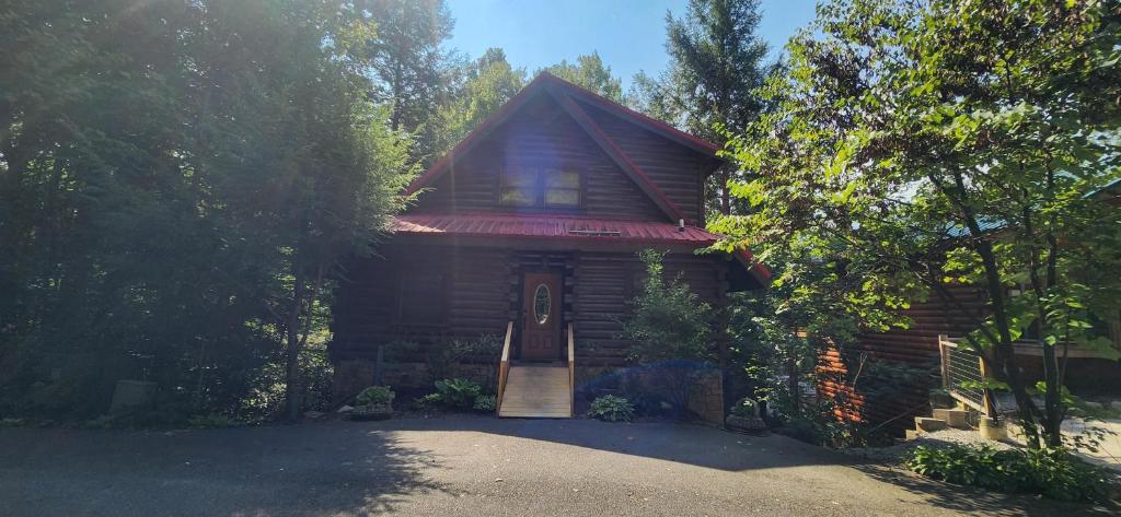 a log cabin with a porch and a door at The Bears Den in Gatlinburg