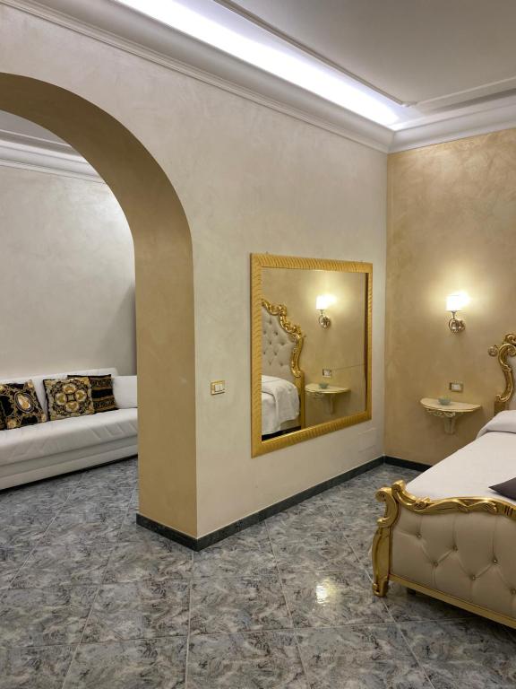 a bedroom with a bed and a mirror on the wall at Suite Incentro Salerno in Salerno