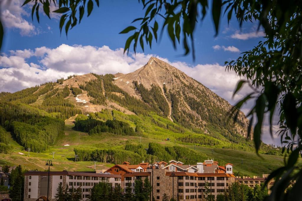 a mountain with a town in front of a city at The Grand Lodge, A Vail Resorts Property in Mount Crested Butte
