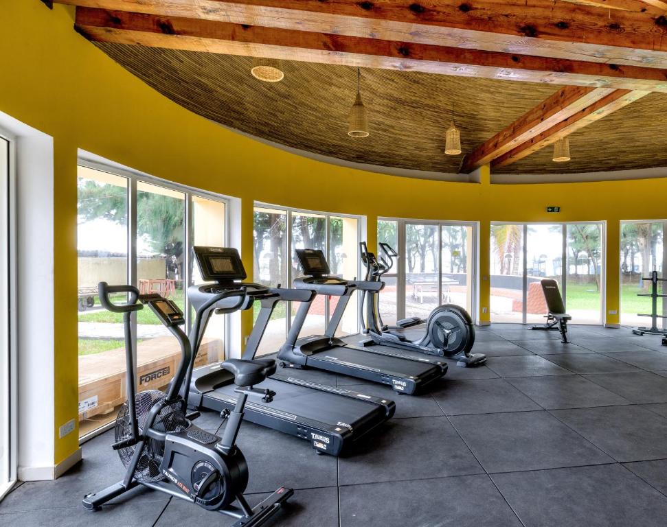 a gym with several treadmills and elliptical machines at Senegambia Beach Hotel in Kololi