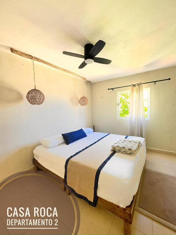 a bedroom with a bed with a ceiling fan at Casa Roca II in Isla Mujeres