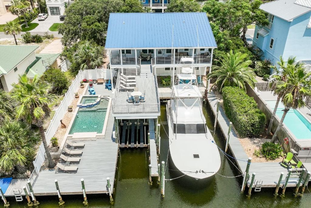 an aerial view of a house with a boat in the water at Harbor On Holiday Isle in Destin