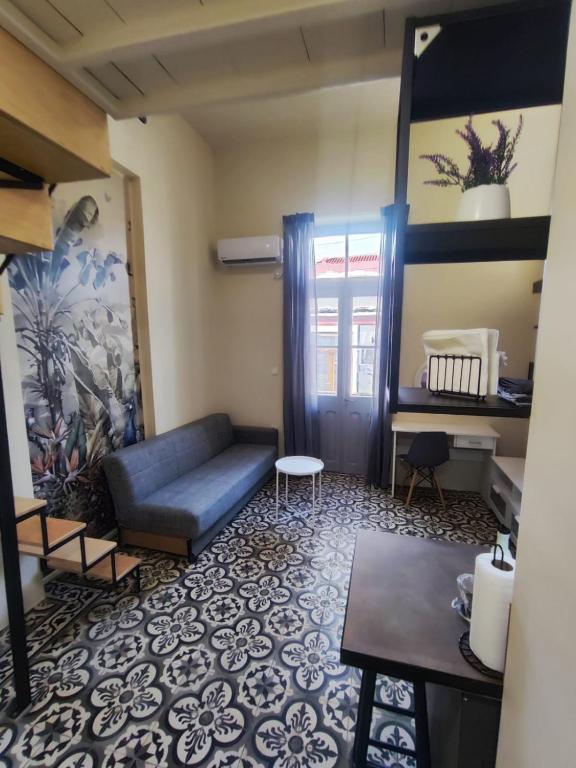 a living room with a couch and a table at Apartment Studio 6 in Mytilene