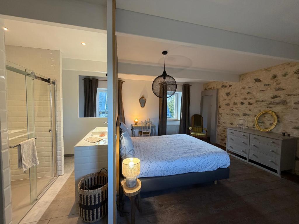 a bedroom with a bed and a walk in shower at LE DOMAINE DE COAT ROGAN, La chambre du Jaudy in Pommerit-Jaudy