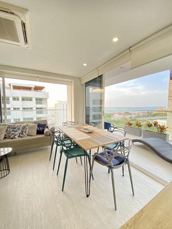 a dining room with a table and chairs and a large window at Luxury Ocean View Aparment in Cartagena de Indias