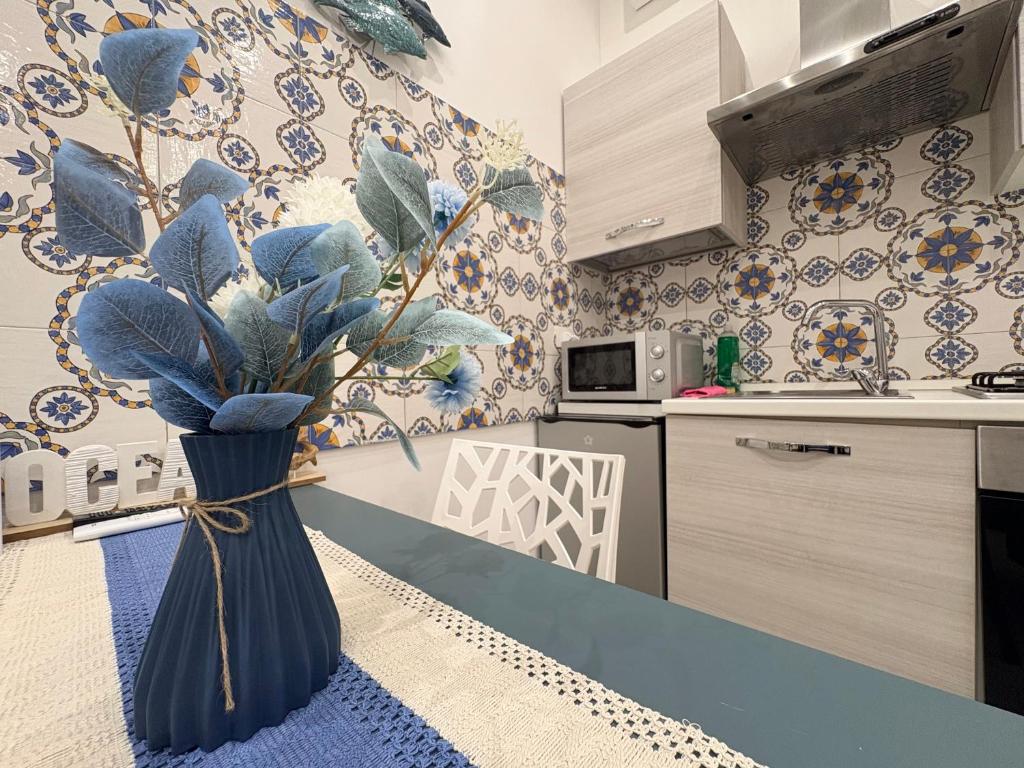 a kitchen with a blue vase on the counter at Vesuvio Rainbow FLY in Naples