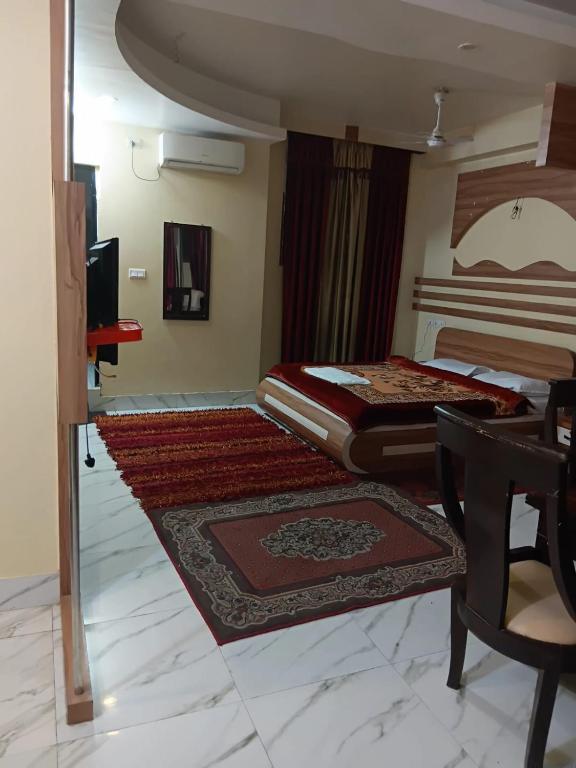 a bedroom with a bed and a desk and a table at Hotel ratna priya pvt ltd in Biratnagar