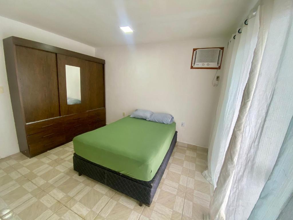a small bedroom with a green bed in a room at Casa Centro do Rio in Rio de Janeiro