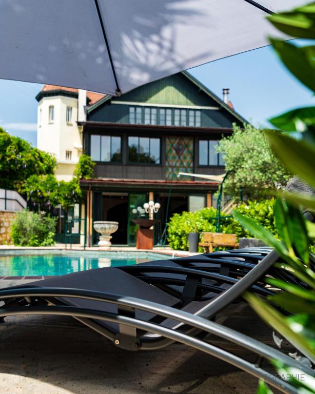 a view of a house with a swimming pool at La Maison cachée du PAVILLON BELLEVUE in Belley