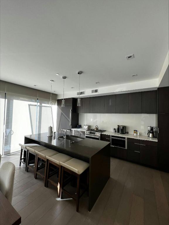 a kitchen with a large black island in a room at Lift Park City Condominiums by Vail Resorts in Park City