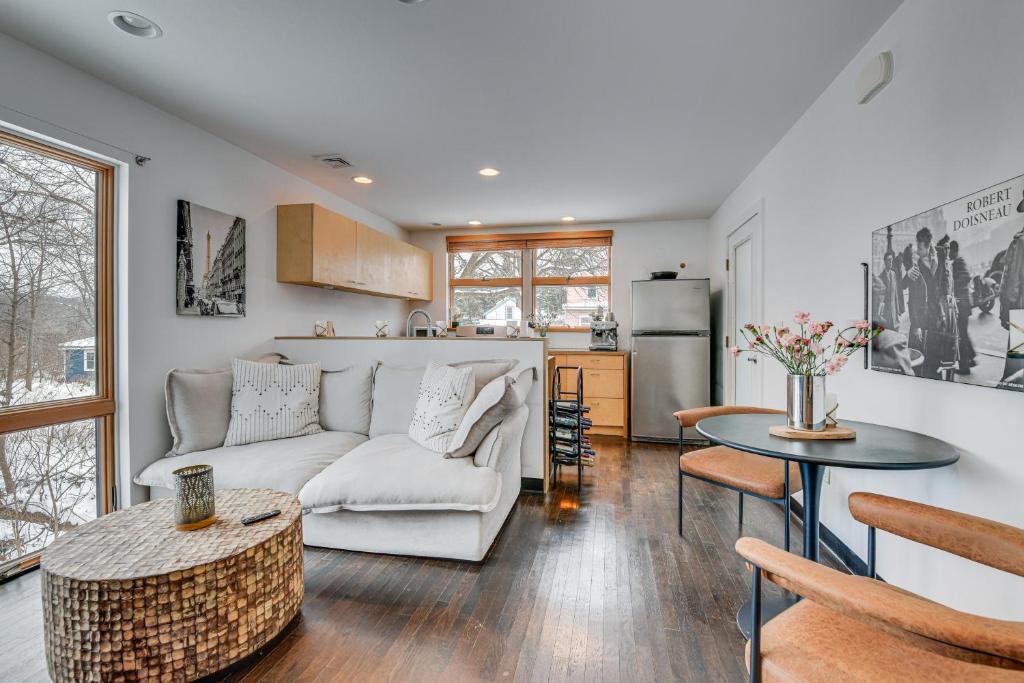 a living room with a couch and a table at Couple’s Retreat Near UVM! Unique Studio w/ Deck in Burlington