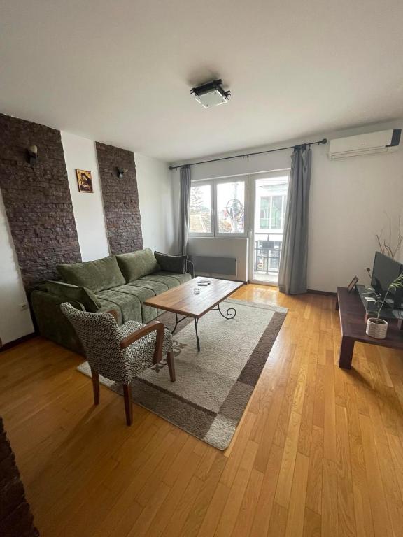 a living room with a couch and a table at Prvi maj in Ub